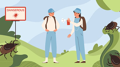 Hikers apply repellent in a grassy area near a tick warning sign.
