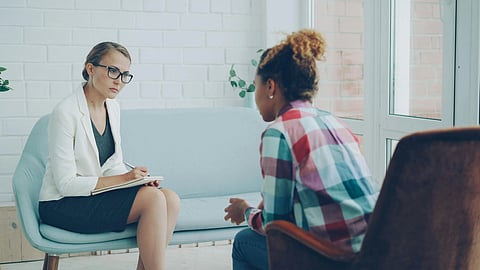 A psychologist sitting with a client.