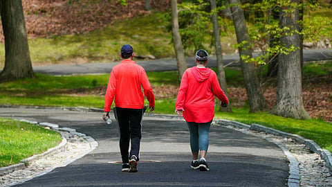 2 people in red jackets, walking.