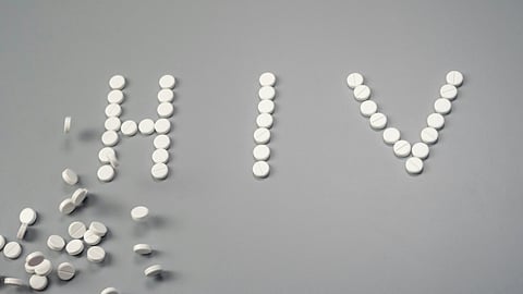 HIV written with white pills.