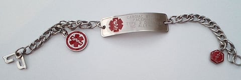 A medical alert bracelet, engraved:
CARDIAC BYPASS
PACEMAKER
TYPE 2 DIABETES
NO ALLERGIES