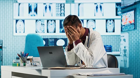 Stressed physician working late at night under pressure fighting to find a cure