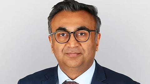 Screenshot of an X post displaying a professional headshot of neurosurgeon Dr. Chirag Patel in a suit and glasses against a plain grey background.