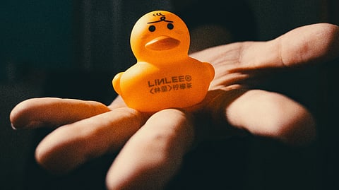 Child with yellow-colored squishy toy in hand. 