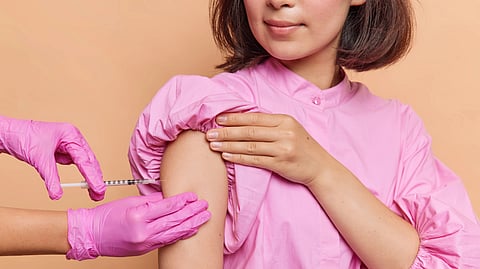 A woman receives an injection.