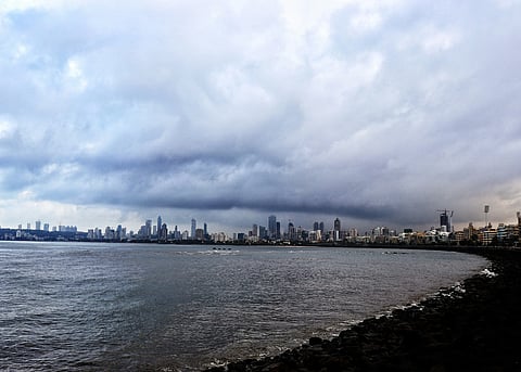 Dark storm clouds rolling over a Mumbai city skyline ahead of pre-monsoon season, thunderstorm asthma risk in India