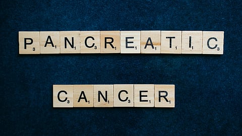 The phrase "pancreatic cancer" spelled out with colorful wooden blocks on a light surface.