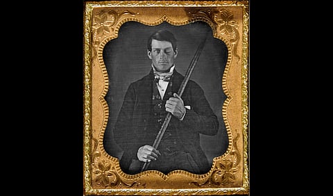 Phineas P. Gage holding the tamping iron which injured him.