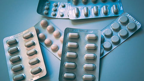 Assorted packaged medicines displayed in multiple blister strips.