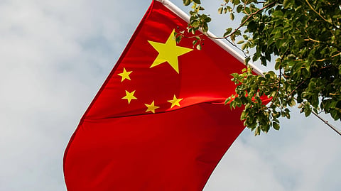 The Chinese flag, a red field with five yellow stars.