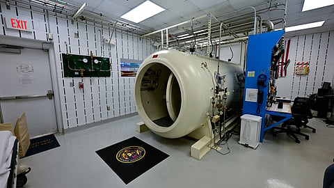 Hyperbaric oxygen chamber used for oxygen inhalation therapy in a hospital setting.