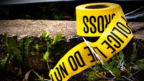 A roll of police tape (police line) lies on the ground 