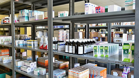A pharmacy storage room with shelves filled with medicines.