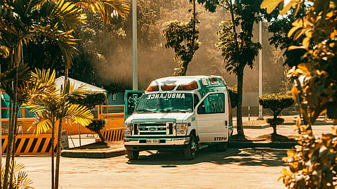 An ambulance parked in a spacious parking area.