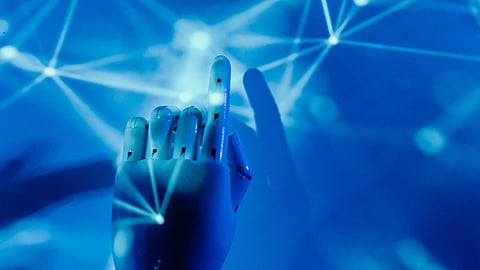 A blue image of a robot hand reaching a glowing network of connected dots.