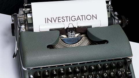 Investigation typed on papaer coming through typewriter.