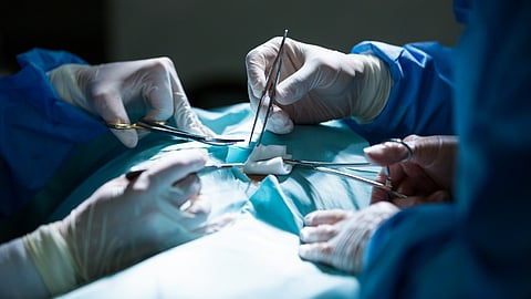 Surgeons performing operation in operation room