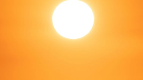 A bright orange sky, with the sun glowing.