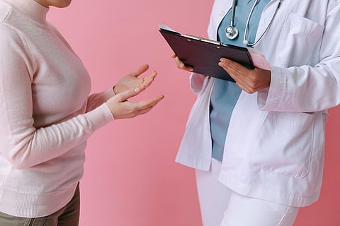 Doctor reviewing patient chart during a clinical consultation