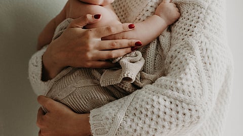 A mother holding a chils.