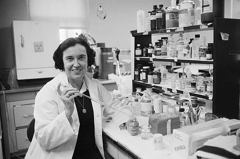 Rosalyn Yalow holding a pipette in her laboratory, surrounded by reagent bottles, circa Bronx VA Hospital