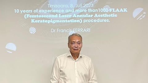 French ophthalmologist Dr. Francis Ferrari wearing a white shirt at a conference.