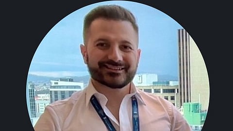 Dr. Arytom in a pink shirt.