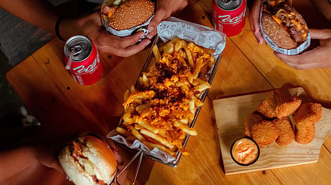 A diverse group of people sharing a meal at a table.
