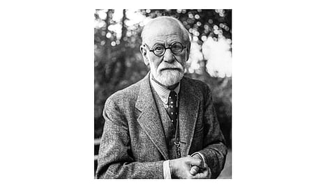 Black-and-white portrait of Sigmund Freud with a serious expression.