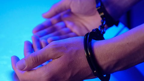 Close-up of hands in handcuffs.