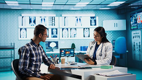 A doctor talks with a patient in a modern clinic.