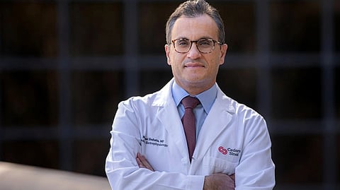 Dr. Michael Shehata in a lab coat, standing with arms crossed at Cedars-Sinai.