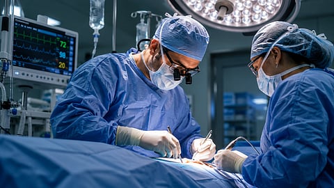Two surgeons performing surgery in an operation theatre