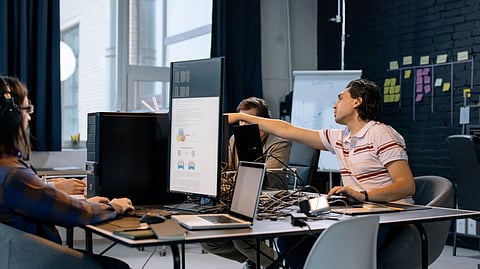 Two people work together in a modern office.