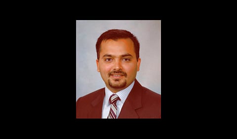 Dr. Sanjeev Kumar wearing a suit