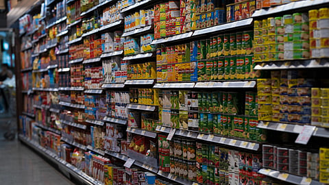 A grocery store aisle filled with neatly stocked packaged food products.
