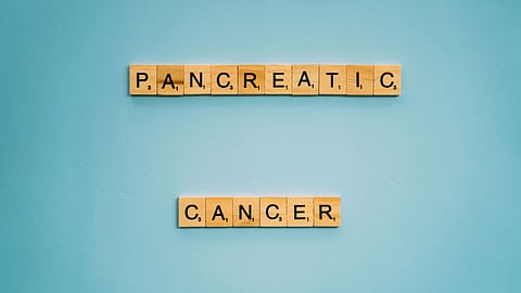 Scrabble tiles spelling "pan-gen-tic cancer" to represent genetic cancer research.