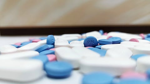 A close-up of colorful pills and tablets scattered together.