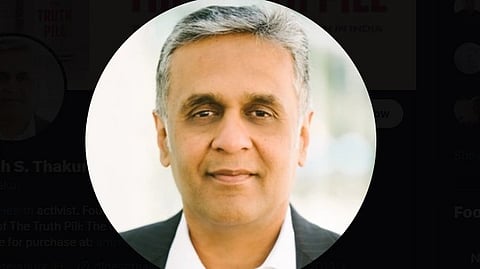 Dinesh Thakur in black coat.