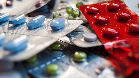 Various tablets and capsules in blister packs.