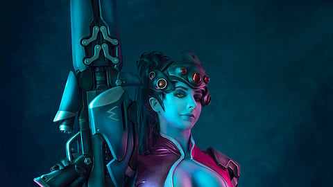 Cosplayer dressed as Widowmaker from Overwatch, wearing a fitted costume and holding a sniper rifle prop, lit in blue and magenta tones.