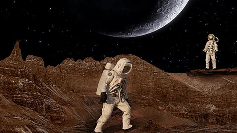 Two astronauts stand on a rocky alien surface under a starry sky.