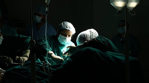 A surgical team performs an operation in the operating room.