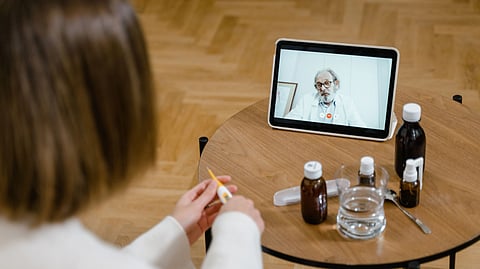 A person attends a telemedicine appointment on a tablet.
