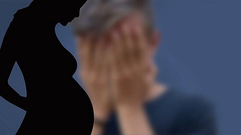 Silhouette of a pregnant woman on the left, with a blurred, distressed figure holding their face in the background.