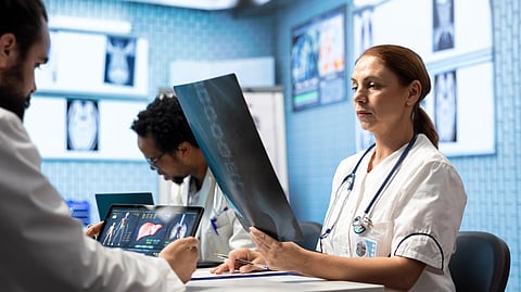 Doctors review X-rays and medical scans in a hospital.
