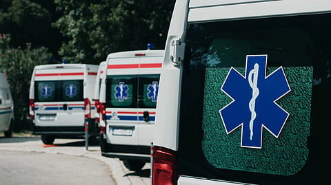 3 ambulances parked in a distance.