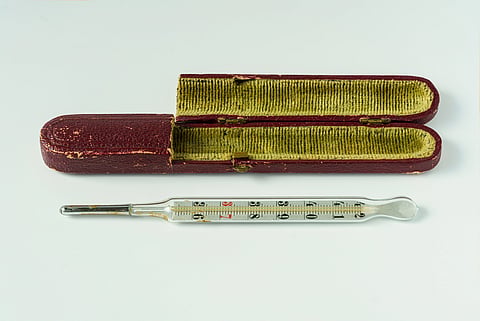 Antique mercury medical thermometer beside its original velvet-lined case, made in Germany before 1920