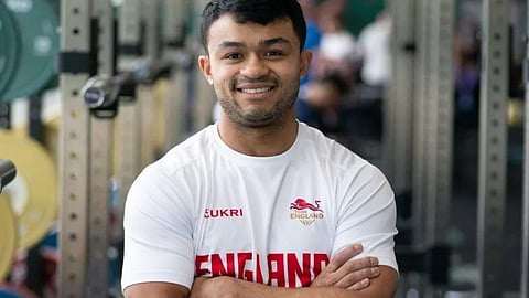Jonathan Chin, NHS doctor and Team England weightlifter, posing in sports attire.