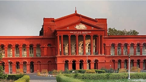 Rust colored building of the Karnataka High Court.
